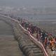 Pilgrims walk on a pontoon bridge to offer prayers at the Sangam.